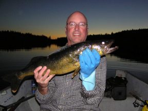 Andy holding Walleye caught at night
